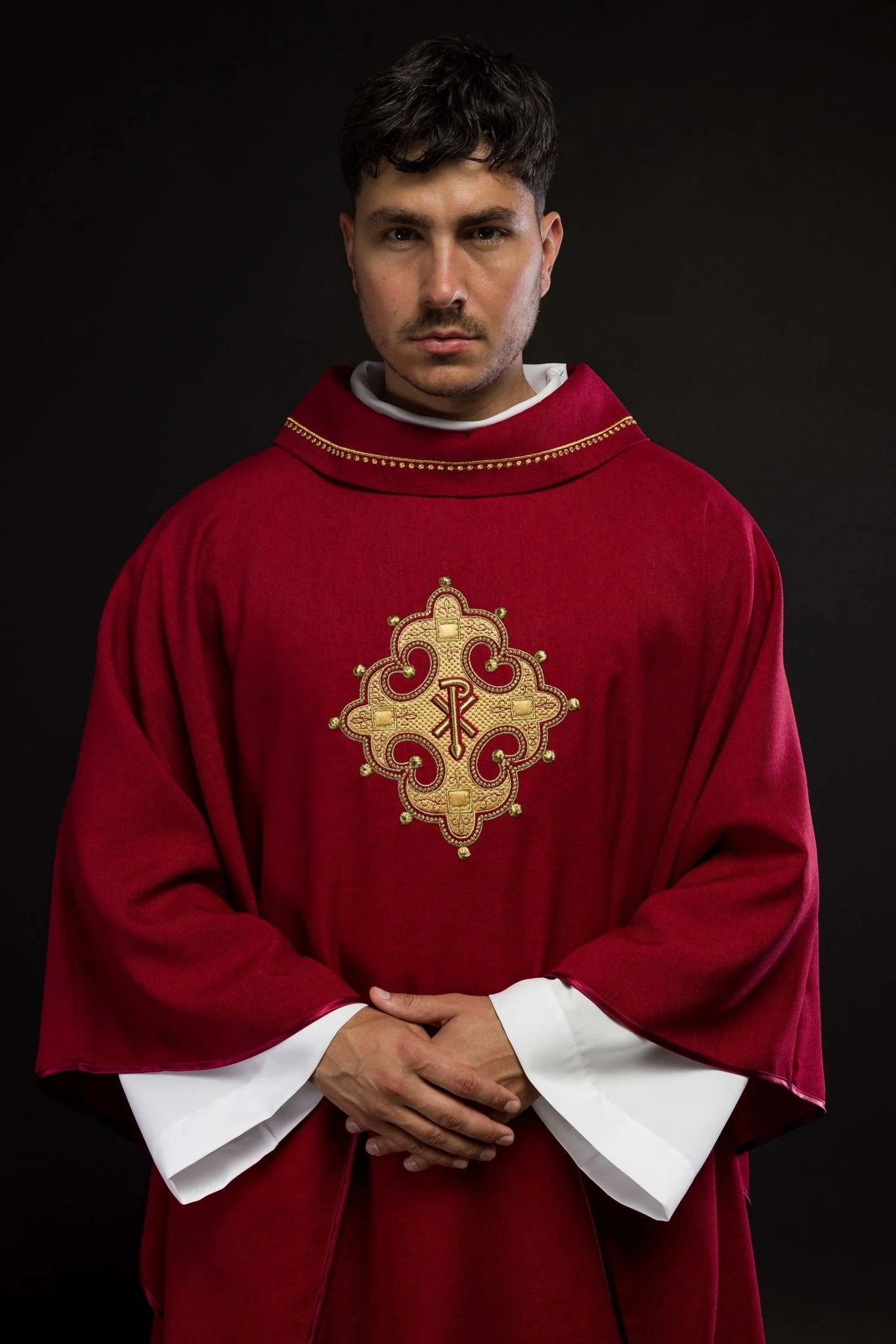 Chasuble with embroidered cross and gold trim on collar in red