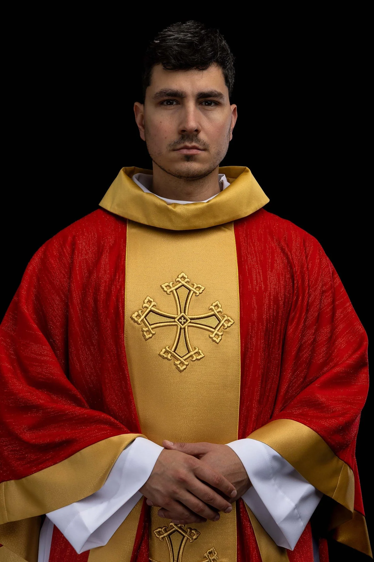 Red chasuble with an embroidered cross motif and a decorative fabric orphrey panel